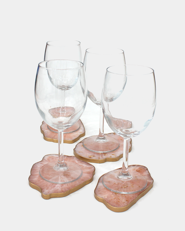 Set of five epoxy resin coasters in beige-marble color with glasses