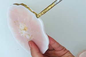 Painting the ends of resin coasters with a brush